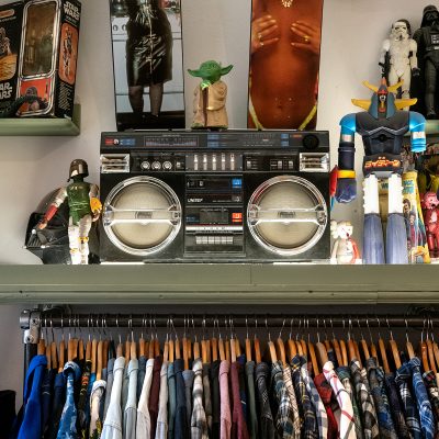 rack with vintage clothing, display with boombox and Nan Goldin-Skateboard decks