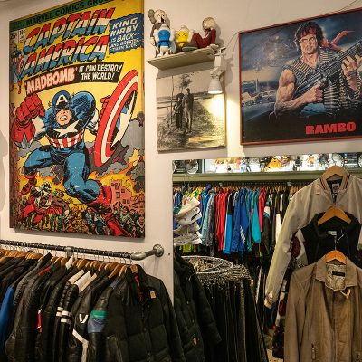 racks with clothing and display of action figures and collectibles and vintage posters