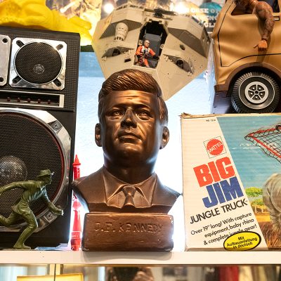 detail shot of shop display with vintage toys and bust of JFK